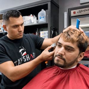 One of the barbers at Stay Sharp providing a haircut.